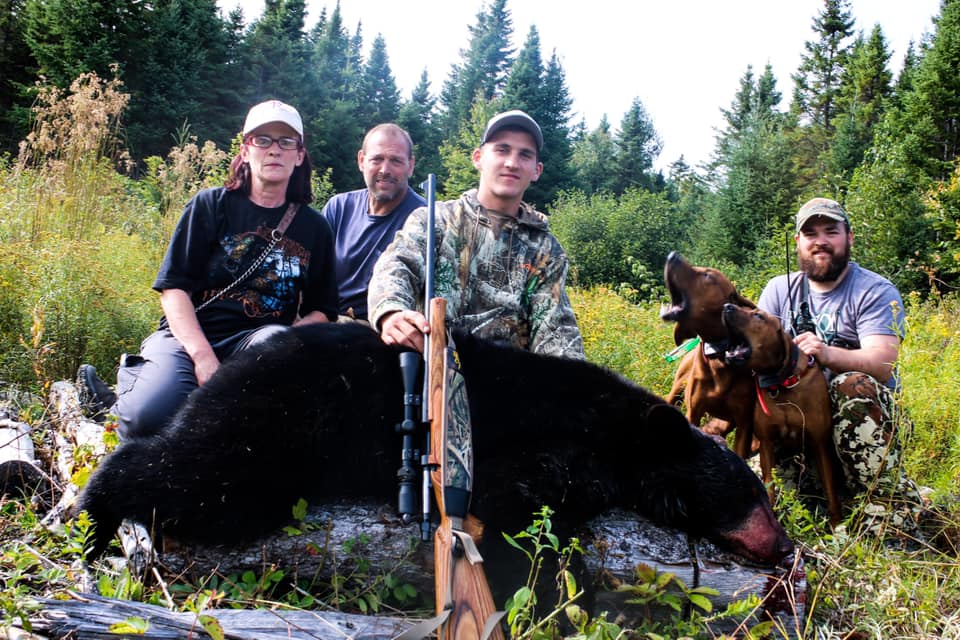 Group of People with Hunted Black Bear