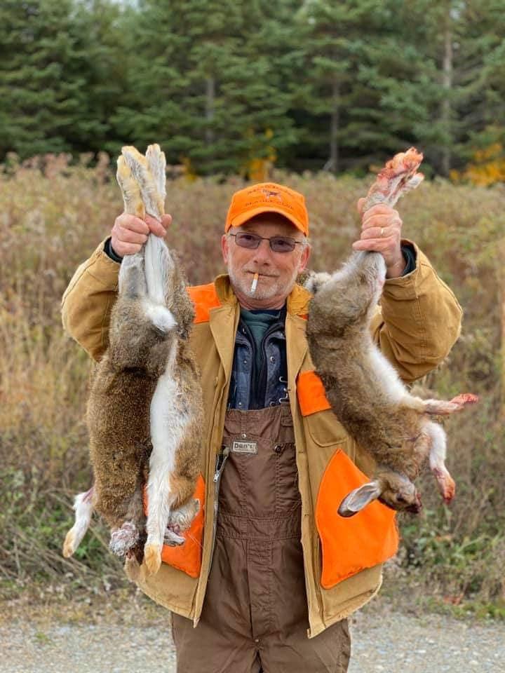 Man Holding Snowshoe Hare