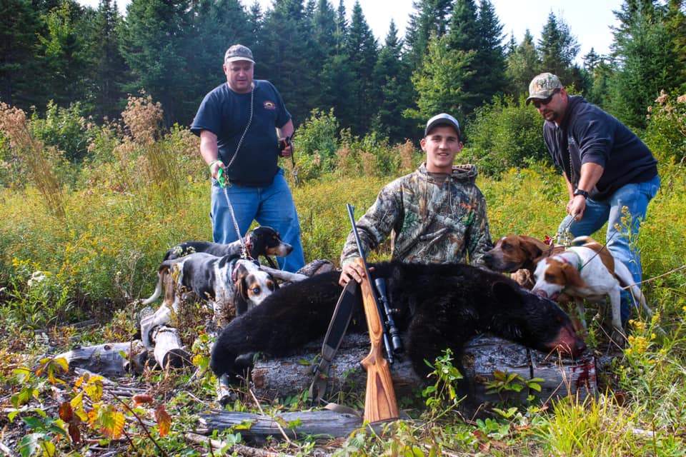 Two Men Posing with Hunted Down Black Bear