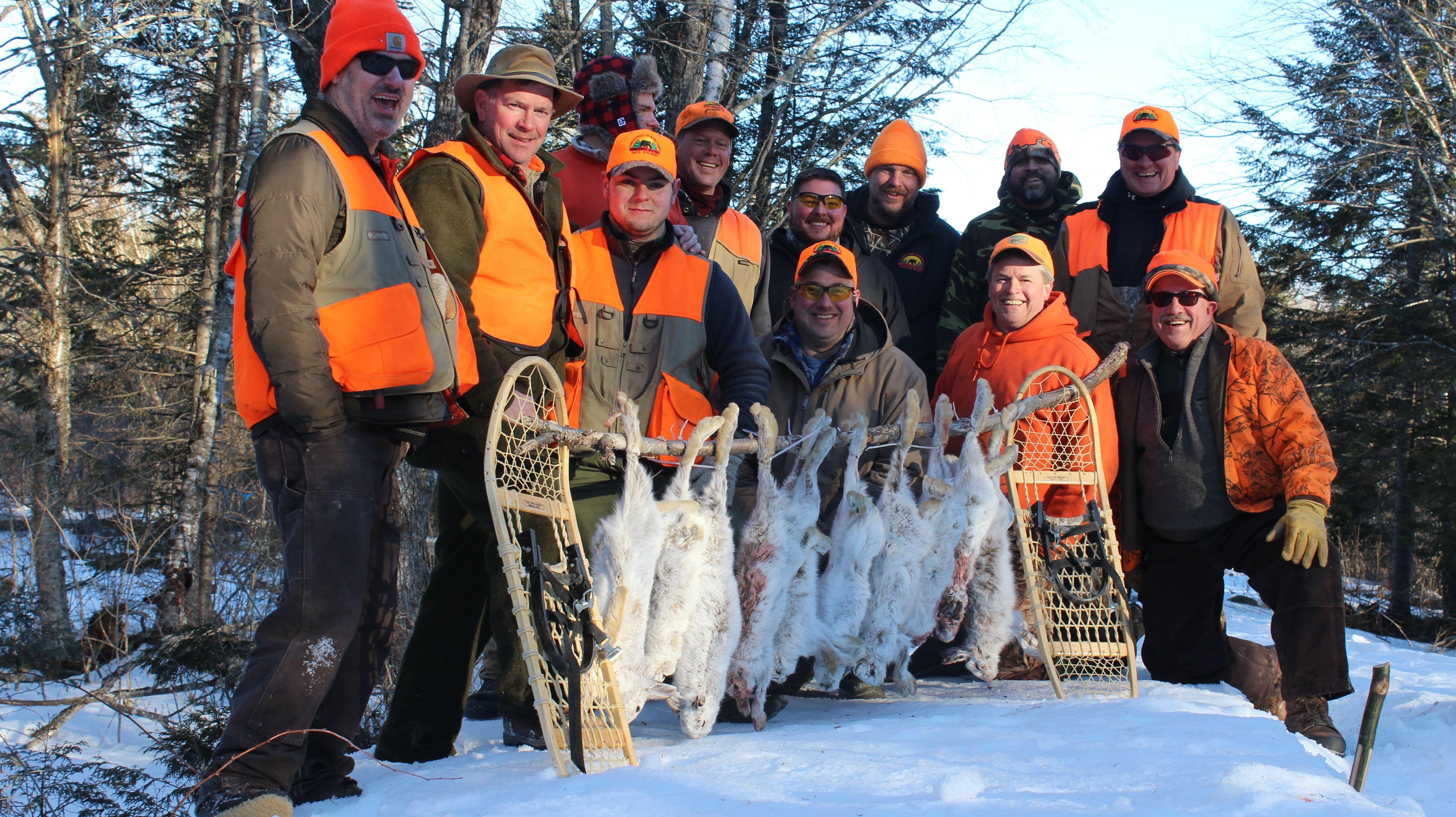 People Holding Hunted Down Snowshoe Hare
